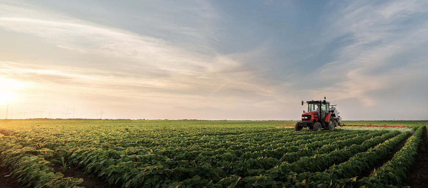 Tractor applying crop protection in a farm field