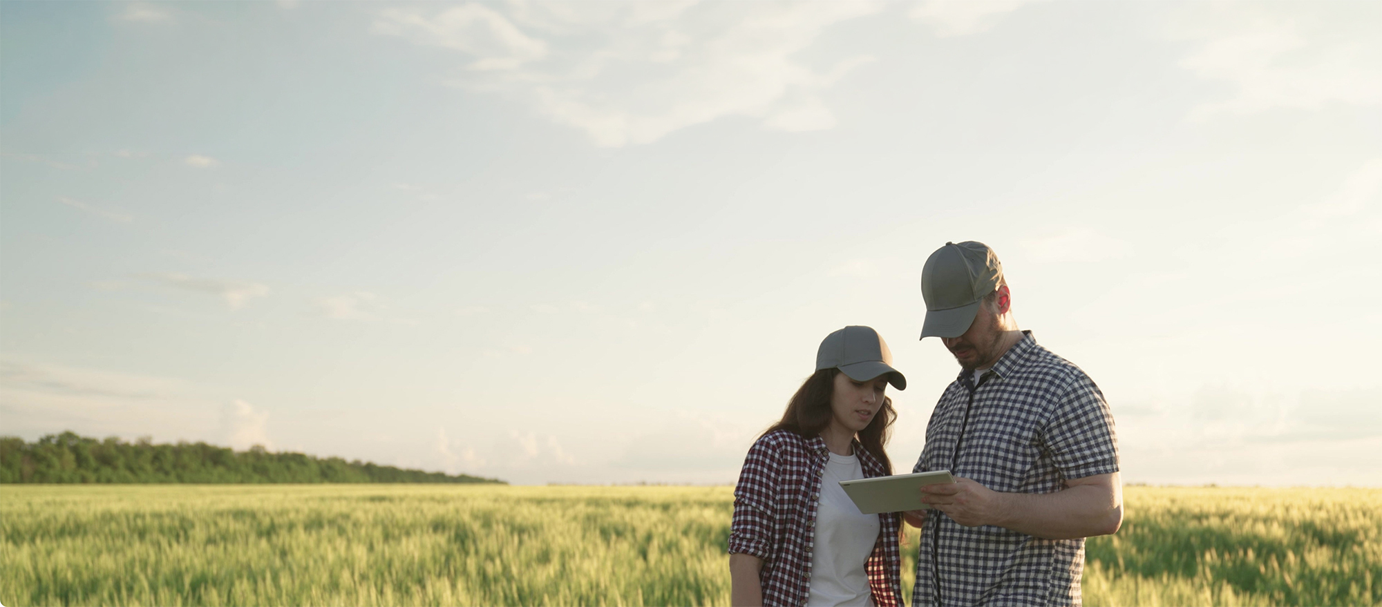 Farmers reviewing a clipboard in a field